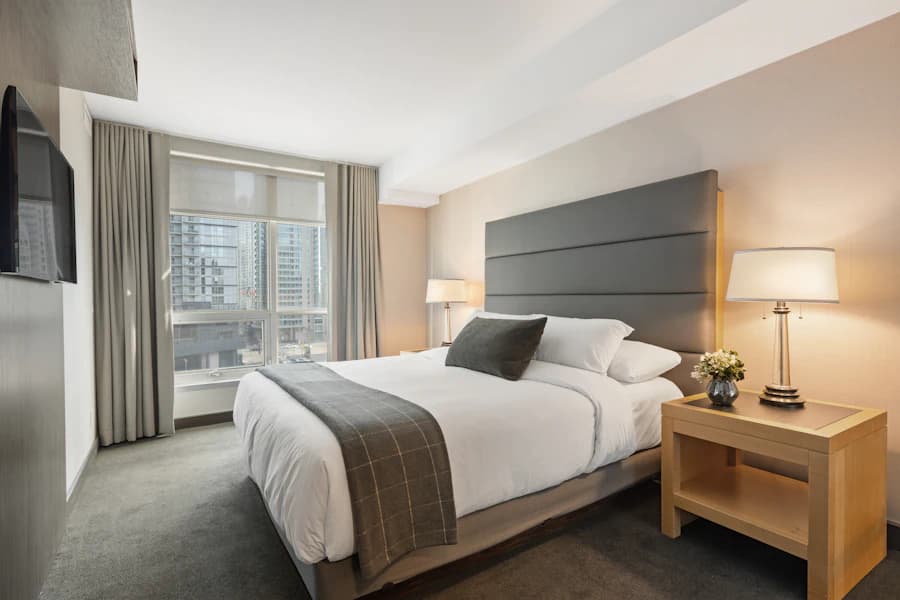 Hotel-style bed made tight with crisp white linens